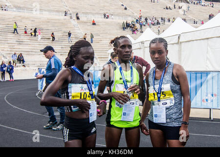 Athens, Greece. 12th Nov, 2017. The three winners in women division are seen after they finished the race. Ethiopia's Badane Bedaru Hipra (R) was the winner, Kenya's Kibor Alice Jepkemboi (L) was second and Kenya's Arusei Nancy Jebichi (M) finished third. The 35th Athens Authentic Marathon takes place today with more than 18500 people participating in the Marathon race, a new participation record. In total, more than 51000 people participated in all races including the Marathon. Credit: Kostas Pikoulas/Pacific Press/Alamy Live News Stock Photo