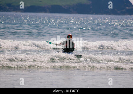 Man sea kayaking on a sunny June summer day on the Keel Beach in Keel, Achill Island, County Mayo, Ireland Stock Photo