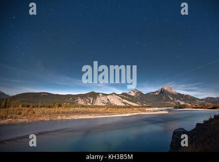 a night sky filled with stars above a mountain in the Canadian Rockies, Alberta Stock Photo