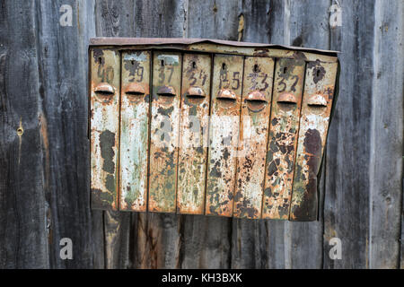 Old Rusty Russian Mailbox. Metal Mailbox rusted over from Soviet times. Stock Photo