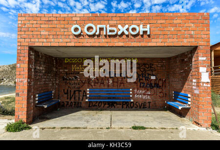 Bus Stop Olkhon Island on Lake Baikal in Russia. Litter amongst the wooden benches and brick enclosure. Stock Photo