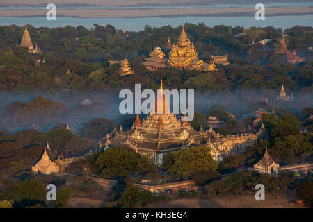 Aerial view of the early morning sunshine on the Ananda Buddhist Temple (foreground) in the ancient city of Bagan in Myanmar (Burma). Dates from 1105A Stock Photo