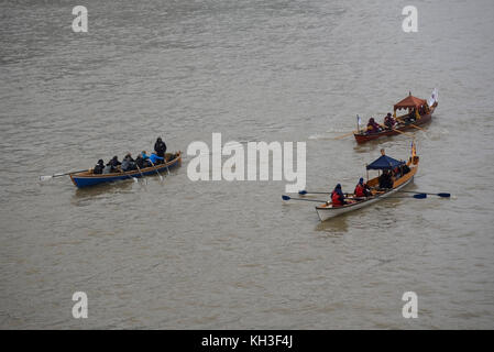 Row boats. Part of the flotilla on the River Thames for the Lord Mayor's Show approaching Tower Bridge Stock Photo