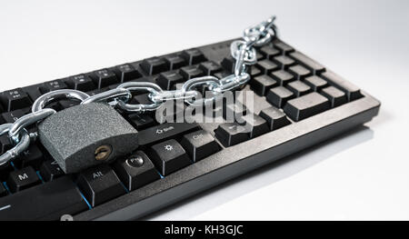 Cyberattack by internet network, office computer keyboard chain and padlock Stock Photo