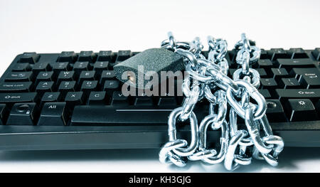 Computer virus protection metaphor, metal chain padlock and keyboard Stock Photo