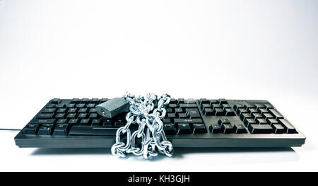 Computer hacker espionage cyberattack, keyboard with chain Stock Photo