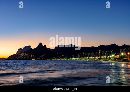 Night arriving at the Arpoador stone, Ipanema beach in Rio de Janeiro Stock Photo