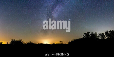 Milky Way panorama with lots of stars and the foreground in silhouette. Stock Photo