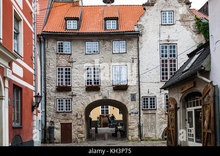 RIGA, LATVIA - SEPTEMBER 3, 2017: people near Swedish Gate on Troksnu iela. The street appeared in Riga in the 16th century, as a passage along the ci Stock Photo