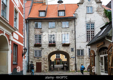 RIGA, LATVIA - SEPTEMBER 3, 2017: tourists near Swedish Gate on Troksnu iela. The street appeared in Riga in the 16th century, as a passage along the  Stock Photo