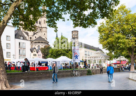 COLOGNE, GERMANY - SEPTEMBER 17, 2017: tourists on outdoor market in Frankenwerft area of Cologne. Cologne is fourth populated city in Germany, it is  Stock Photo