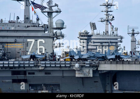 The aircraft carriers USS Ronald Reagan (CVN 76) and USS Nimitz (CVN 68) transit the Western Pacific Stock Photo