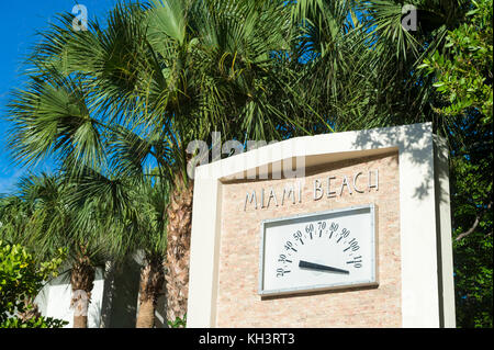 Art deco temperature gauge surrounded by palm trees in Lummus Park, Miami Beach Stock Photo