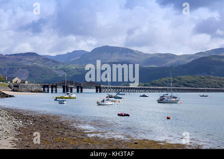 Barmouth railway bridge over Mawddach Estuary for the Cambrian Coast Railway Line, Snowdonia in distance, Barmouth,Gwynedd,Wales,UK Stock Photo