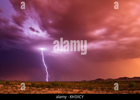 Vivid lightning bolt during a monsoon thunderstorm in the Arizona desert at sunset near Gila Bend Stock Photo