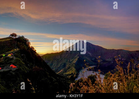 Sunrise Mount Rinjani vulcano with tents Lombok Indonesia Stock Photo