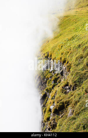 Mist from Gullfoss (Golden Falls) waterfall shrouds the surrounding landscape in Iceland. Stock Photo
