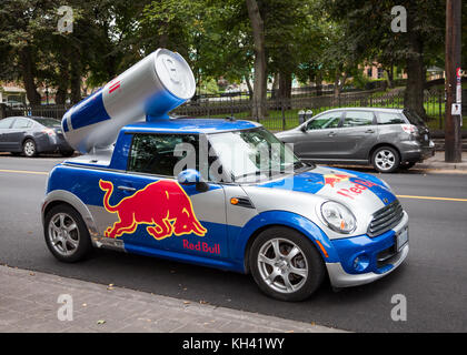A Red Bull mini cooper publicity car with a can of Red Bull drink in Halifax, Nova Scotia, Canada, Stock Photo