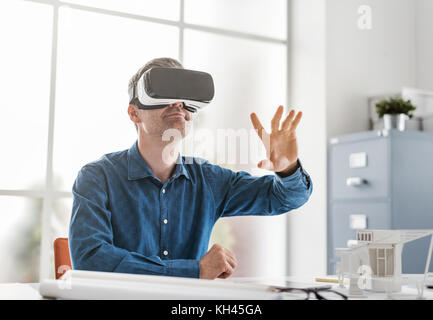 Professional architect working with virtual reality headset and interacting with a virtual environment, innovation and technology concept Stock Photo