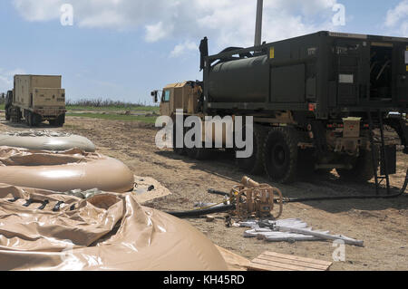 A M977 Heavy Expanded Mobility Tactical Truck receives purified water in its 2,000 gallon water tank at the Roosevelt Roads water station in Puerto Rico, October 14. For survivors of Hurricane Maria who do not have access to clean, usable water, a multipronged approach is in place to ensure potable water is available to all residents. (U.S. Army photo by: Sgt. Michael Eaddy) Stock Photo