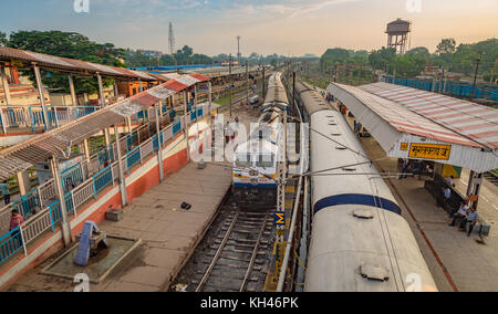 View of Mughalsarai Junction railway station at sunrise with a diesel locomotive engine arriving at a platform. Stock Photo