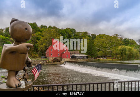 The historic Red Mill in Clinton NJ with bronze sculpture of little boy  in foreground Stock Photo