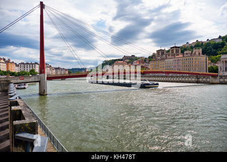 A Barge Passing Under the Gateway Courthouse Footbridge, Lyon, France Stock Photo