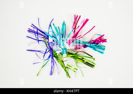 colorful party blowouts and noisemakers with streamers isolated on a solid background Stock Photo