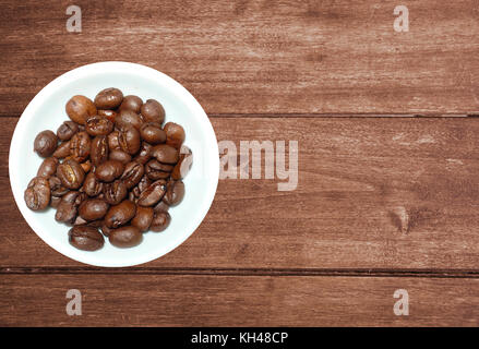 variety of tea in strands and coffee beans on rustic wooden background Stock Photo