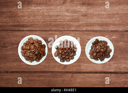 variety of tea in strands and coffee beans on rustic wooden background Stock Photo