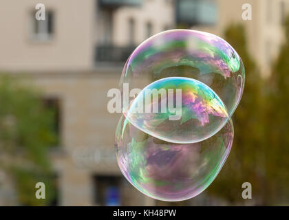 Soap bubbles in front of an old house and trees in Dresden Germany in autumn Stock Photo