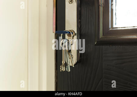 Close up of key in black composite front door of house Stock Photo