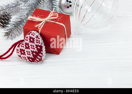 handmade present box with decorative heart, christmas tree decorations on white wooden boards Stock Photo