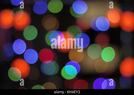 Color light blurred background, green, blue, red and yellow lights unfocused. Christmas decorations, garland illumination bokeh Stock Photo