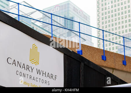 London, UK - November 24, 2017 - New development construction site in Canary Wharf with elevated DLR rail track and Citigroup Center building in the b Stock Photo