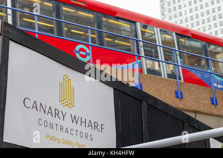 London, UK - November 24, 2017 - New development construction site in Canary Wharf with DLR train passing in the background Stock Photo