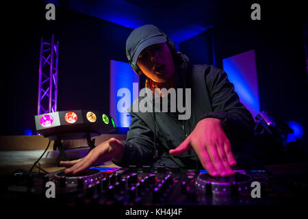 Disc jockey at the turntable dj plays on the best famous cd players at nightclub, france Stock Photo