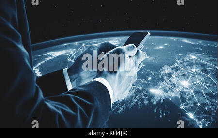 Businessman using mobile smart phone with global network connection. Elements of this image are furnished by NASA Stock Photo