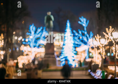 Helsinki, Finland. Defocused Blue Bokeh Background With Statue Of Johan Ludvig Runeberg On Esplanadi Park In Lighting At Evening Night Illumination. L Stock Photo