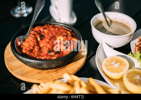 Batumi, Adjara, Georgia. Dishes Of Georgian National Cuisine: Satsivi Or Walnut Sauce And Stewed Mussels. Stock Photo