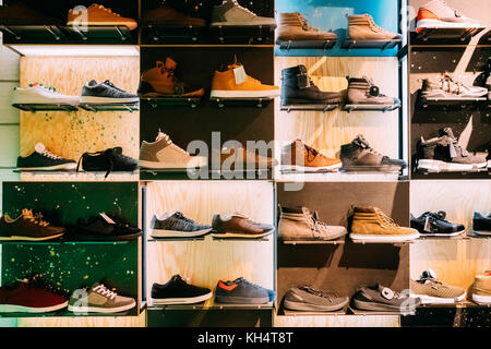 Fashion Casual Male Sneakers On Shelves In Store Of Shopping Center. Stock Photo