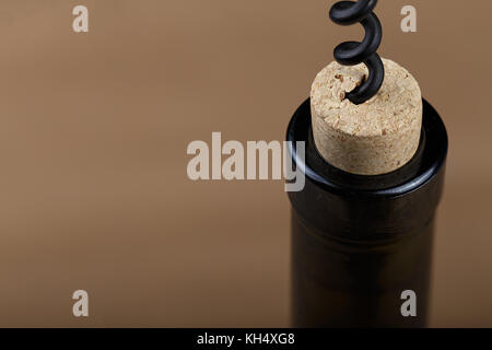 a bottle of wine is opened with a corkscrew, a corkscrew is screwed into a bottle stopper Stock Photo