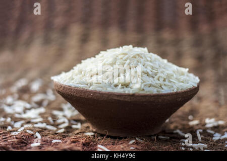 Uncooked White Basmati rice in a clay bowl. Stock Photo