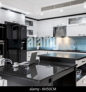 Black and white, stylish, high gloss kitchen with island Stock Photo