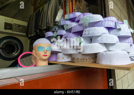 Muslim caps for sale in a shop, Qinghai province, Xining, China Stock Photo