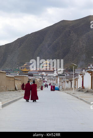 Tibetan monks walking in the streets of Labrang monastery, Gansu province, Labrang, China