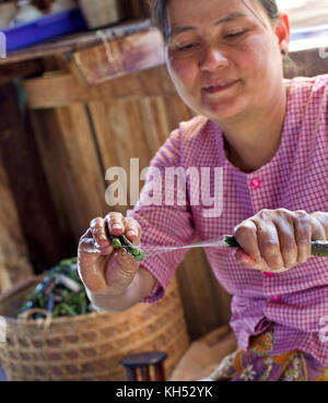 Local Inle Lake Myanmar women silk from Lotus plant in Burma Stock Photo