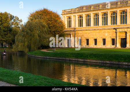 Scenic view of the Wren Library at sunset, Trinity College, Cambridge University; with punting in front on the river Cam, UK.