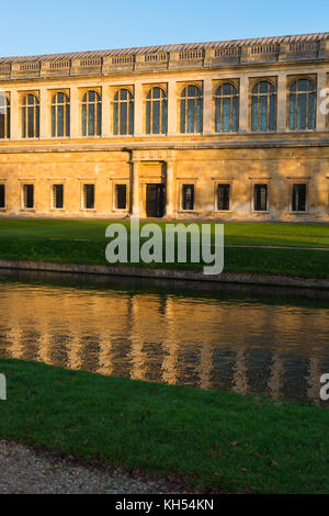 Scenic view of the Wren Library at sunset, Trinity College, Cambridge University; with punting in front on the river Cam, UK. Stock Photo