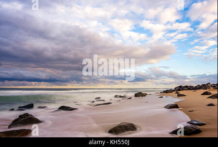 Compelling clouds in the evening over the beach in New Jersey Stock Photo